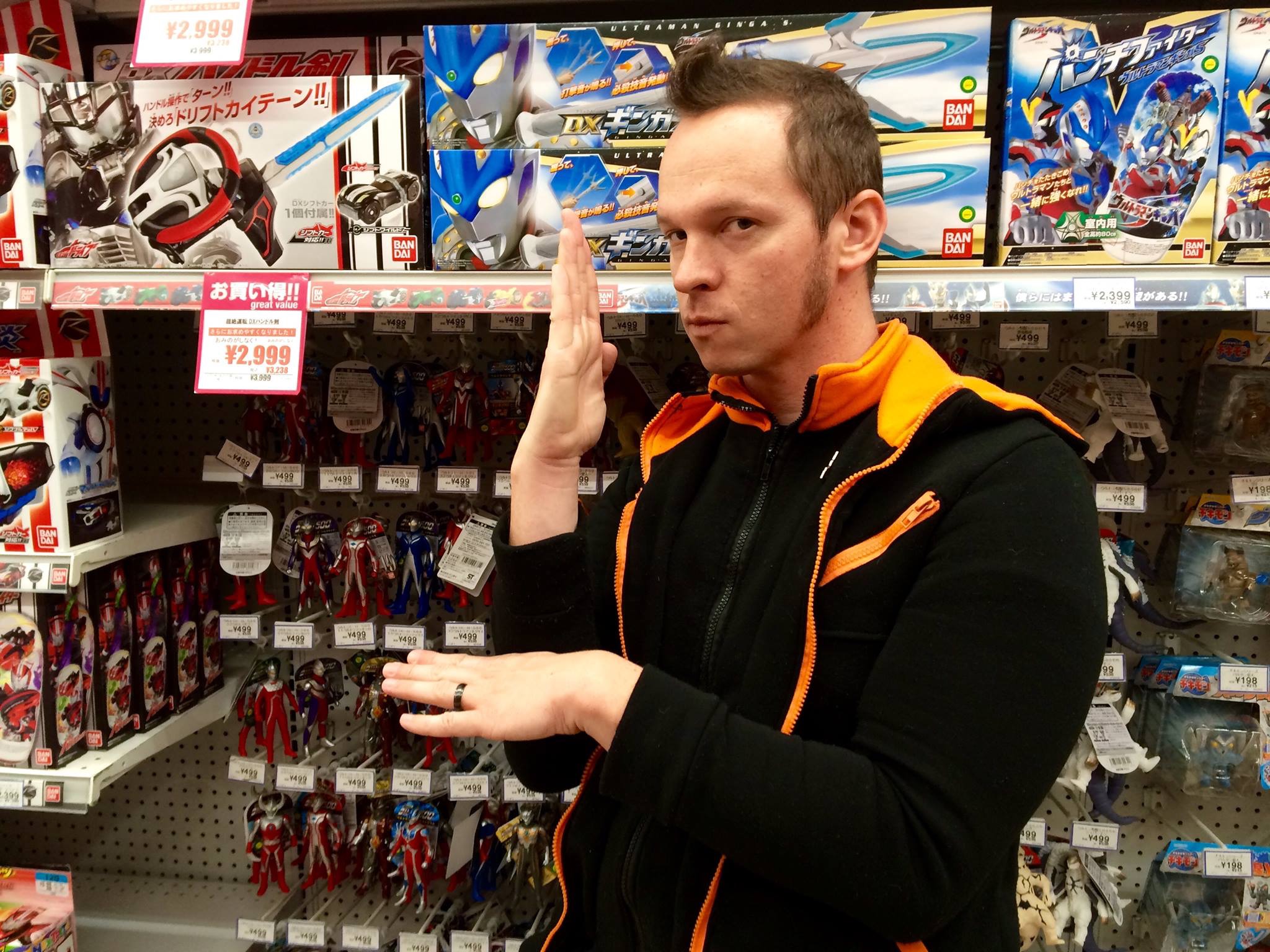 Gaz is in Japan standing in front of a display of Ultraman Toys